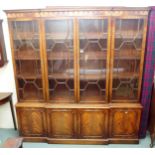 A 20th century mahogany breakfront glazed bookcase with dentil cornice over four astragal glazed