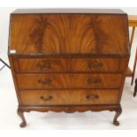 A 20th century mahogany writing bureau with fitted fall front writing compartment over two over