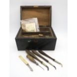 A case of specialist gilders' tools, to include a packet of gold powder and a book of gold leaf