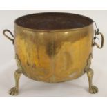 A 19th century brass log bin with twin riveted handles on three paw feet Condition Report: