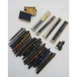 A large collection of pens and propelling pencils, including a number of 14k-nibbed examples, a