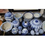 A collection of blue and white pottery including Chinese pumpkin shaped jars and covers, ginger jar,