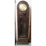 A 20th century oak cased long case clock with brass face bearing Arabic numerals over glazed cabinet