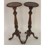 A pair of early 20th century mahogany tripod based torchiere plant stands (2) Condition Report: