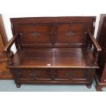 A 20th century oak monks bench with lidded seat on turned ball feet Condition Report:Available