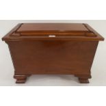 An early 20th century mahogany sarcophagus cellarette with hinged top concealing metal liner on