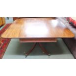 A Victorian mahogany single drawer drop side table on quadrupedal base with brass casters