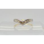 An 18ct gold baguette cut diamond 'V' shaped ring, set with estimated approx 0.35cts, size P, weight