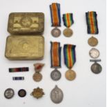 A quantity of WW1 medals and badges, comprising two Defence Medal and British War Medal pairings (