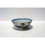 A delft blue and white dish with painted Chinese landscape decoration, 17cm diameter Condition
