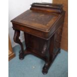 A Victorian walnut Davenport writing desk with gallery topped stationary compartment over writing