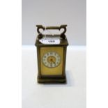 A French brass and glass carriage clock with enamel chapter ring with arabic numerals Condition