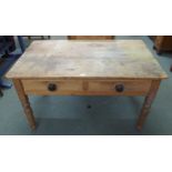 A late Victorian pine two drawer kitchen table on turned supports, 69cm high x 122cm wide x 75cm