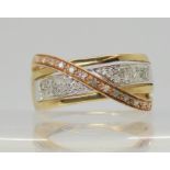 A 9ct three colour gold diamond dress ring set with estimated approx 0.15cts of brilliant cut