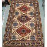 A cream ground eastern rug with three geometric medallions and multicoloured borders, 225cm long x