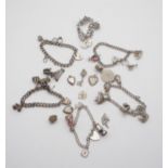 A collection of five silver and white metal children's charm bracelets with silver and white metal