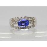 A 9ct white gold, tanzanite, baguette and brilliant cut diamond dress ring, size O, weight 8.4gms