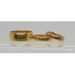 Two 18ct gold wedding bands, sizes W & Q, weight 8.7gms, together with a 9ct rose gold example
