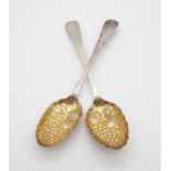 A pair of provincial silver Old English pattern berry spoons, with bright engraved decoration, by