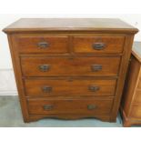 An early 20th century oak two over three chest of drawers with shaped copper drawer pulls, 102cm