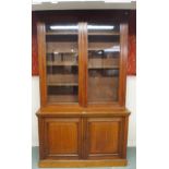 A Victorian oak bookcase with shaped dentil cornice over pair of glazed doors over pair of cabinet