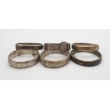 A collection of silver bangles with floral engraved decoration, one Birmingham 1962, another by