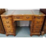A 20th century mahogany twin pedestal desk with green embossed leather skivers over single drawer
