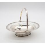 An Edwardian silver swing handled basket, of oval form, the rim and handle with cast leaf