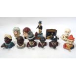 A collection of cast iron money banks, including Uncle Sam, Punch & Judy and skeleton examples