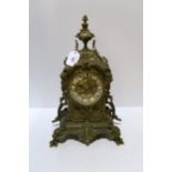 A French cast gilt metal mantle clock, with enamel roman numeral baton, the movement marked Japy