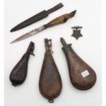 Two leather powder flasks, together with a brass and copper example, a hunting knife with deer