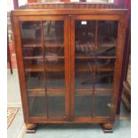 A 20th century stained oak glazed two door bookcase, 128cm high x 95cm wide x 29cm deep Condition