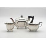 An Art Deco Bachelor's silver tea service, the bodies faceted, on four paw feet, by Emile Viner,