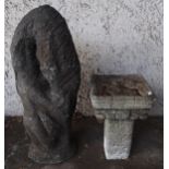 A 20th century unfinished carved stone garden statue of a couple in embrace and a stoneware birdbath