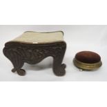 An early 20th century oak footstool with Celtic style carvings and Victorian upholstered stool