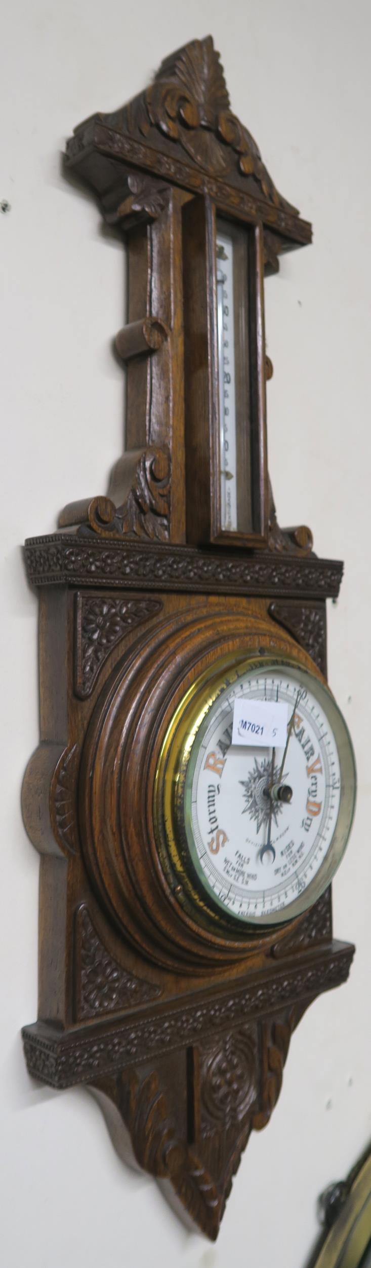 A 20th century carved oak barometer/thermometer and brass framed circular wall mirror (2) - Image 8 of 8