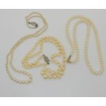 Three strings of cultured pearls to include two with 9ct clasps one diamond set. Condition Report: