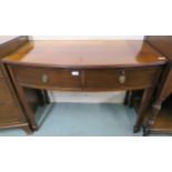 A 20th century mahogany bow front two drawer table on square tapering supports, 75cm high x 104cm