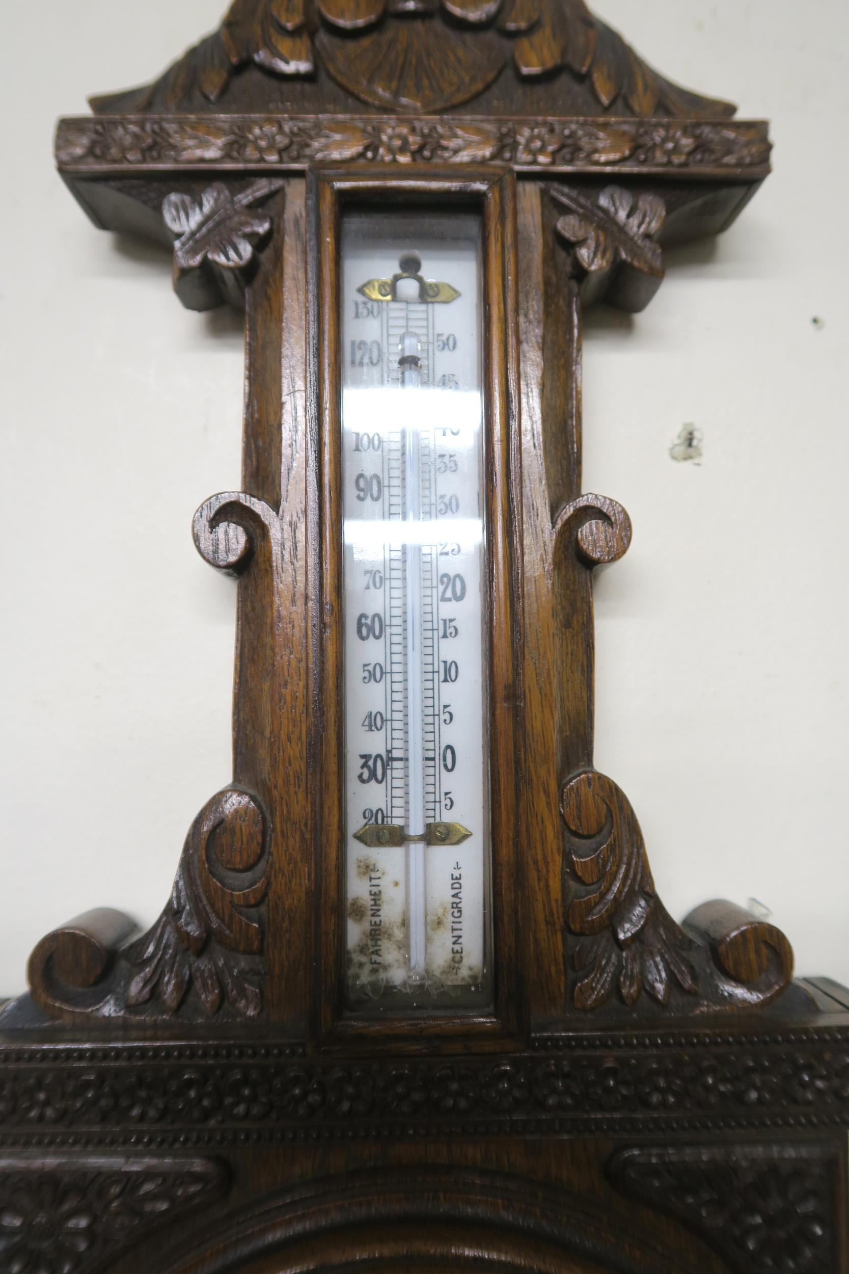 A 20th century carved oak barometer/thermometer and brass framed circular wall mirror (2) - Image 5 of 8