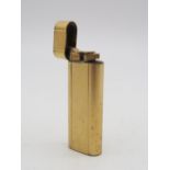A Cartier Plaque d'Or gold-plated cigarette lighter Condition Report:Available upon request