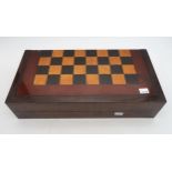 A rosewood chess/backgammon games box, containing bone dominoes, draughts pieces and a London Sights