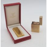 A boxed Cartier Plaque d'Or cigarette lighter, the lid engraved "To Chris, with love, Kevin"; and
