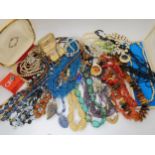 A string of baltic amber beads, coral beads, horn beads, two pairs of boxed Ciro earrings containing