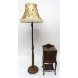 A 20th century mahogany serpentine front single door bedside and a mahogany turned standard lamp (2)