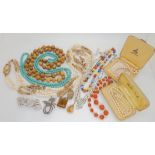 A colection of vintage costume jewellery to include carnelian beads, deco clips, glass gem