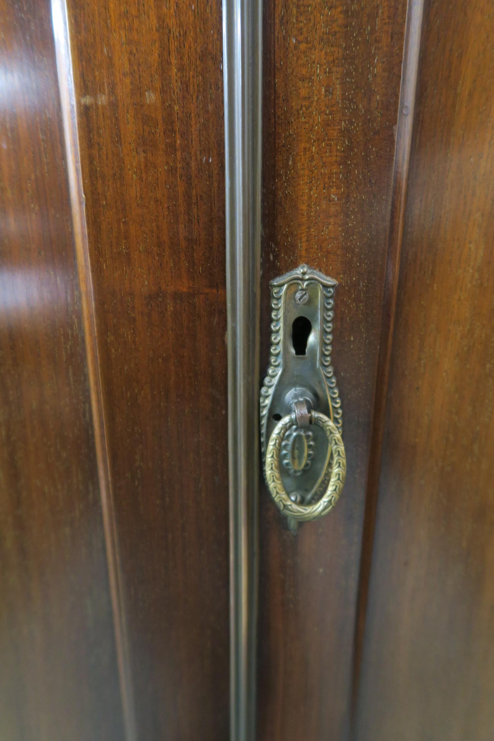 A 20th century mahogany wardrobe with moulded cornice over pair of panel doors on bracket base, - Image 3 of 6