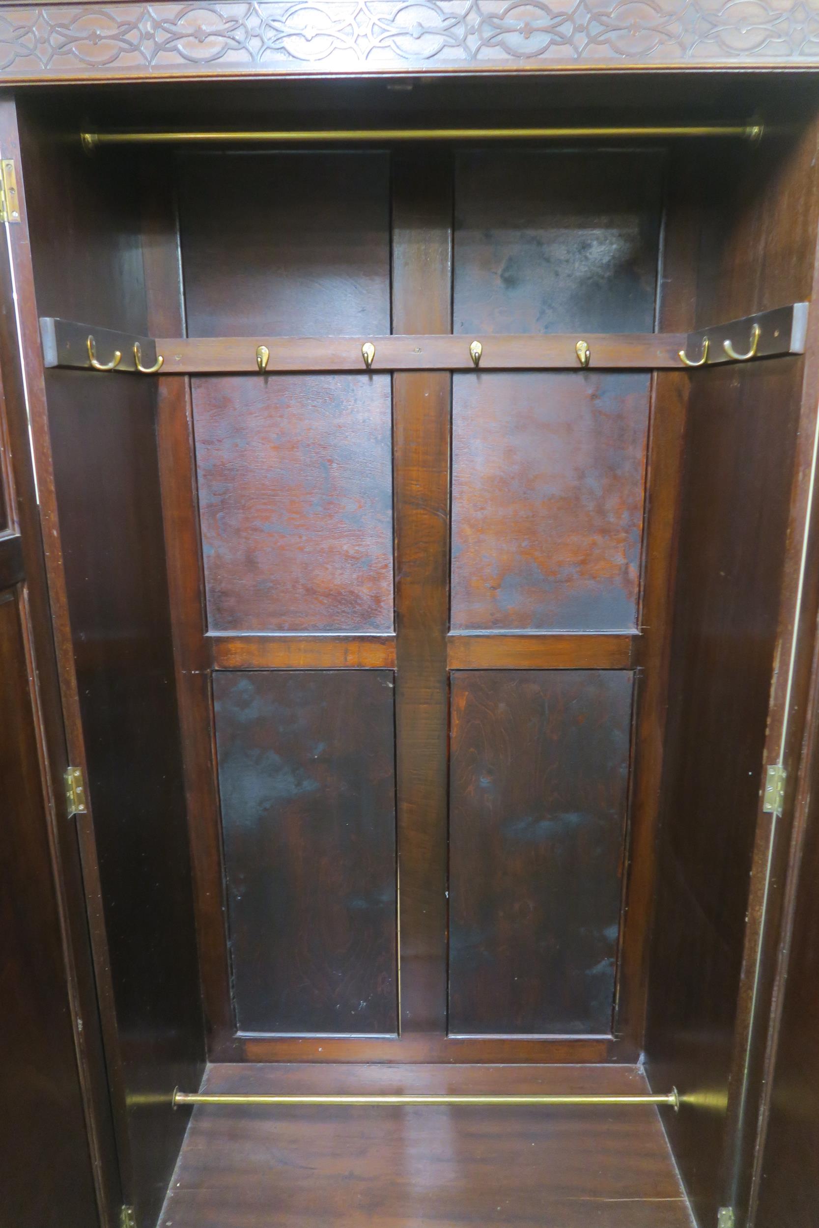 A 20th century mahogany wardrobe with moulded cornice over pair of panel doors on bracket base, - Image 4 of 6