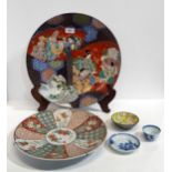 A Japanese charger decorated with figures, another charger, a Nanking Cargo tea bowl and saucer, and