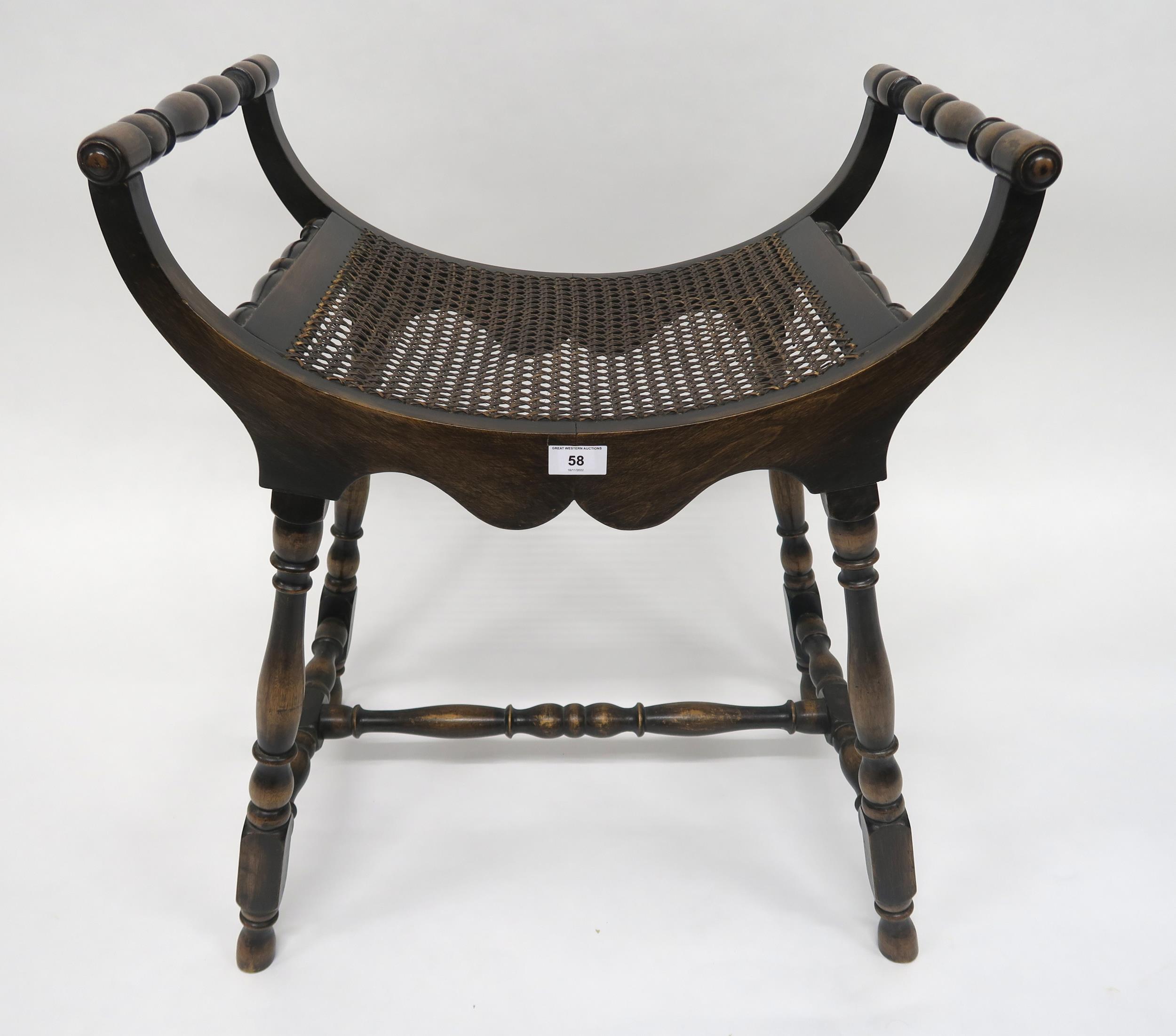 A 20th century mahogany bergere stool with turned arms and stretchered supports, 69cm high x 59cm