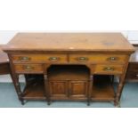 An early 20th century oak sideboard with two long over two short drawers over pair of cabinet doors,